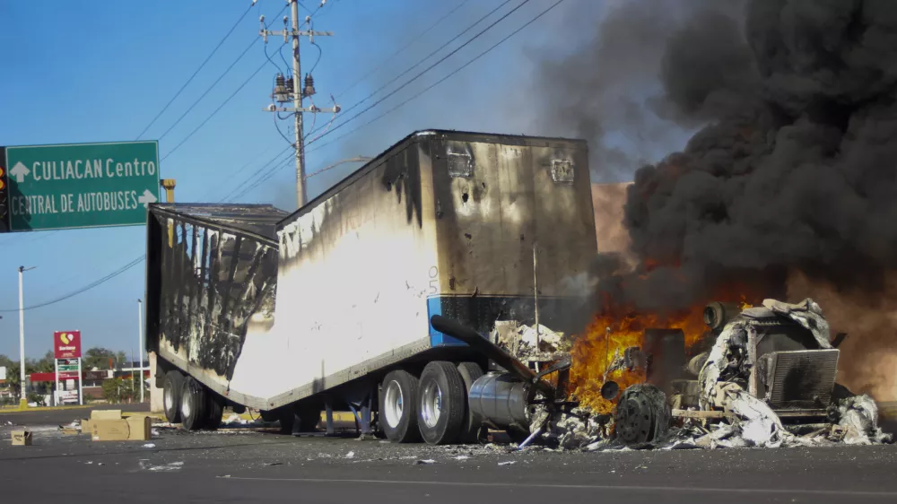 FILE - A truck burns on a street in Culiacan, Sinaloa state, Mexico, Jan. 5, 2023, after Mexican security forces captured Ovidio Guzm&aacute;n, a son of former Sinaloa cartel boss Joaqu&iacute;n "El Chapo" Guzm&aacute;n, which set off gunfights and roadblocks. (AP Photo/Martin Urista, File)