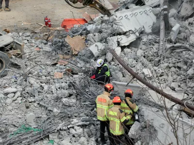 Rescue workers participate in a salvage operation at a collapsed highway construction site in Cheonan, South Korea, February 25, 2025.  REUTERS/Kim Hong-ji