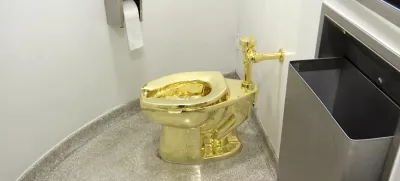 FILE - This screenshot made from a video shows the 18-karat toilet, titled "America," by Maurizio Cattelan in the restroom of the Solomon R. Guggenheim Museum in New York, Sept. 16, 2016. (AP Photo, File)