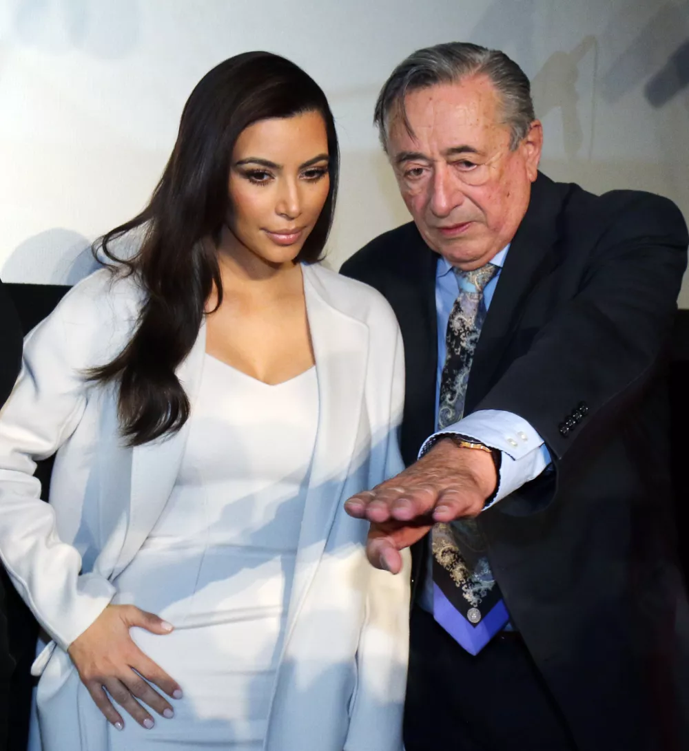 Television personality Kim Kardashian and Austrian businessman Richard Lugner, from left, arrive for a news conference in Vienna, Austria, Thursday, Feb. 27, 2014. Kardashian will be Lugner's special guest at this year's Opera Ball. (AP Photo/Ronald Zak)