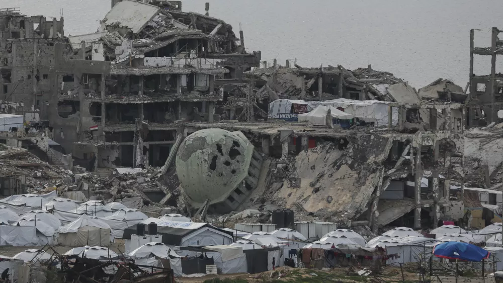 A tent camp for displaced Palestinians is set up amid destroyed buildings in the west of Al-Shati camp, west of Gaza City, on Monday, March 3, 2025. (AP Photo/Jehad Alshrafi)