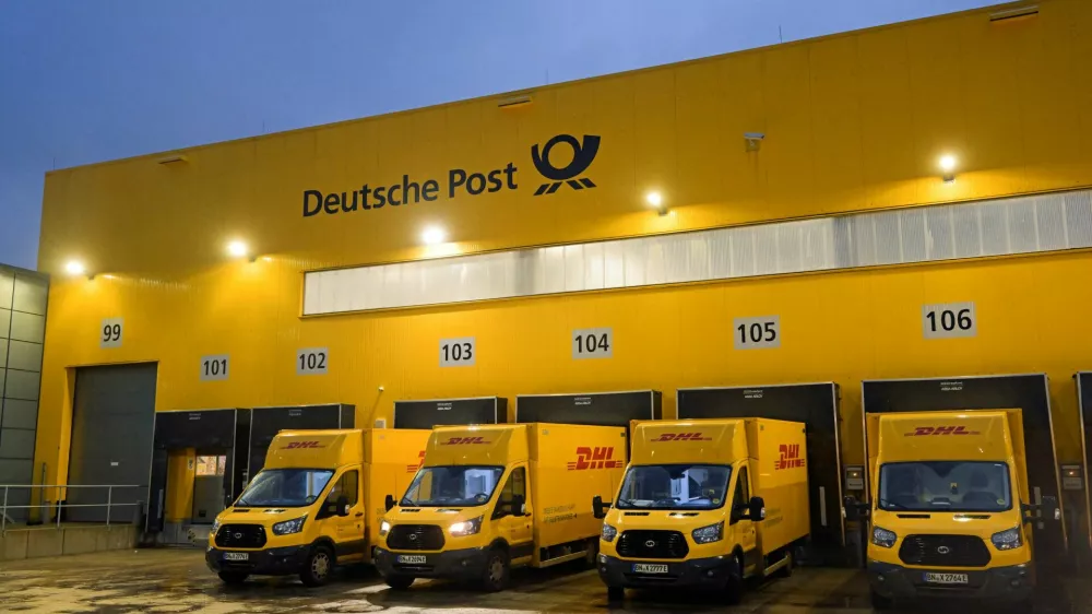 FILE PHOTO: Delivery cars are lined up at a distribution centre of German postal and logistics group Deutsche Post DHL in Hamburg, Germany, December 8, 2022. REUTERS/Fabian Bimmer/File Photo