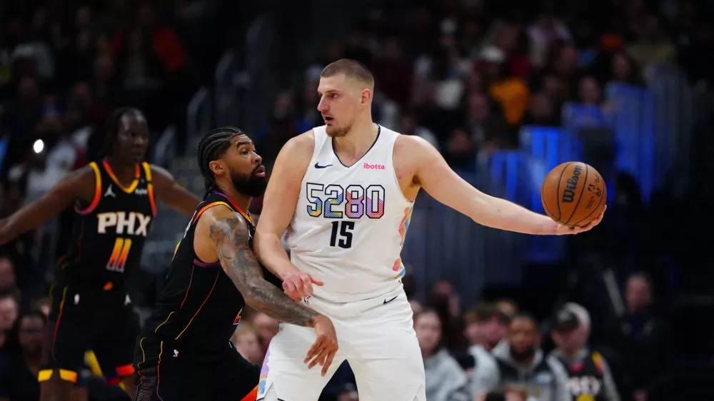 Mar 7, 2025; Denver, Colorado, USA; Phoenix Suns center Nick Richards (2) defends on Denver Nuggets center Nikola Jokic (15) in the first quarter at Ball Arena. Mandatory Credit: Ron Chenoy-Imagn Images
