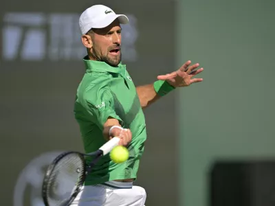Mar 8, 2025; Indian Wells, CA, USA; Novak Djokovic (SRB) hits a shot against Botic Van De Zandschulp (not pictured) during the second round of the BNP Paribas Open at the Indian Well Tennis Garden. Mandatory Credit: Jayne Kamin-Oncea-Imagn Images