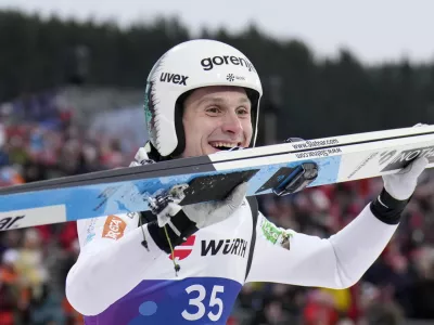 Domen Prevc, of Slovenia, celebrates after winning the gold medal in the ski jumping men's large hill individual competition at the Nordic World Ski Championships in Trondheim, Norway, Saturday, March 8, 2025. (AP Photo/Matthias Schrader)