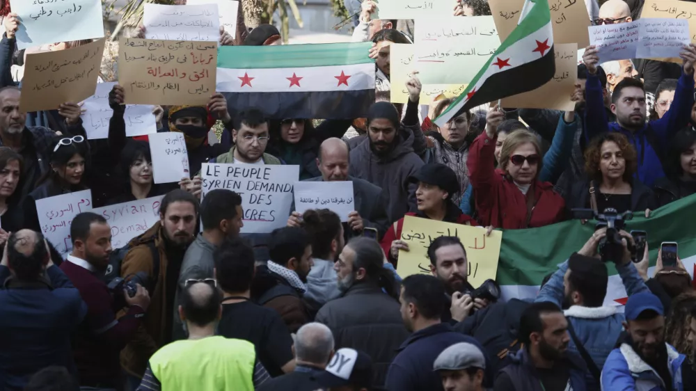 Activists protest against the recent wave of violence and sectarian attacks in Syria's coastal region, in Damascus, Syria, Sunday, March 9, 2025. (AP Photo/Omar Sanadiki)