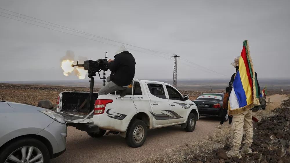 A Druze militiaman fires from a machine-gun attached on the back of a truck during a shooting practice in the southern province of Sweida, Syria, March 4, 2025. (AP Photo/Omar Sanadiki)