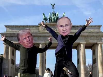 From left, Activists wearing masks of US President Donald Trump, left, and Russian President Vladimir Putin, protest against the support of the US and Russia for the far-right AfD party in front of the Brandenburg Gate in Berlin, Germany, Thursday, Feb. 20, 2025. (AP Photo/Ebrahim Noroozi)