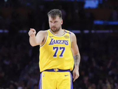 Los Angeles Lakers' Luka Doncic (77) points to his teammate after making a basket during the second half of an NBA basketball game against the New Orleans Pelicans Tuesday, March 4, 2025, in Los Angeles. (AP Photo/Jae C. Hong)