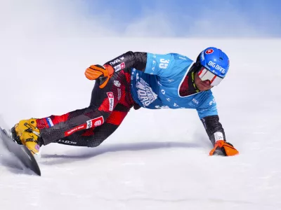 Slovakian Zan Kosir races in qualification round of the men's parallel slalom FIS Snowboard Alpine World Cup at Val Saint-Come in Saint-Come, Quebec, Canada, on Saturday, Feb. 15, 2025. (Sean Kilpatrick/The Canadian Press via AP)