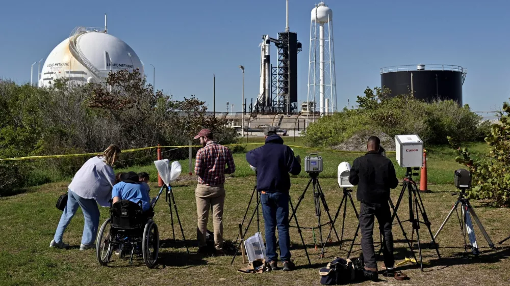 Photographers set up remote cameras for a SpaceX Falcon 9 rocket launch outside Launch Complex 39A where it is scheduled to carry a crew of four to the International Space Station from the Kennedy Space Center in Cape Canaveral, Florida, U.S. March 12, 2025. REUTERS/Steve Nesius