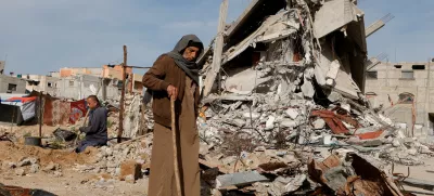 FILE PHOTO: A Palestinian man walks near rubble of houses destroyed during the Israeli offensive, in Rafah, in the southern Gaza Strip, March 13, 2025. REUTERS/Hatem Khaled/File Photo