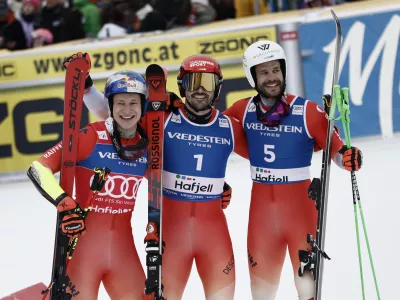 Switzerland's Loic Meillard, center, winner of an alpine ski, men's World Cup Giant Slalom, celebrates with second-placed Switzerland's Marco Odermatt, left, and third-placed Switzerland's Thomas Tumler, in Hafjell, Norway, Saturday, March 15, 2025. (AP Photo/Gabriele Facciotti)