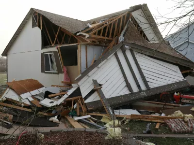 Debris lies around a damaged home the morning after a tornado touched down in Florissant, Missouri, U.S. March 15, 2025. REUTERS/Lawrence Bryant