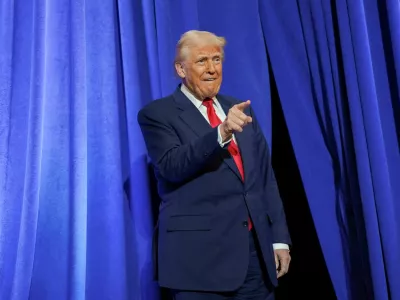 U.S. President Donald Trump gestures during his visit to the Department of Justice to address its workers, in Washington, D.C., U.S., March 14, 2025. REUTERS/Nathan Howard