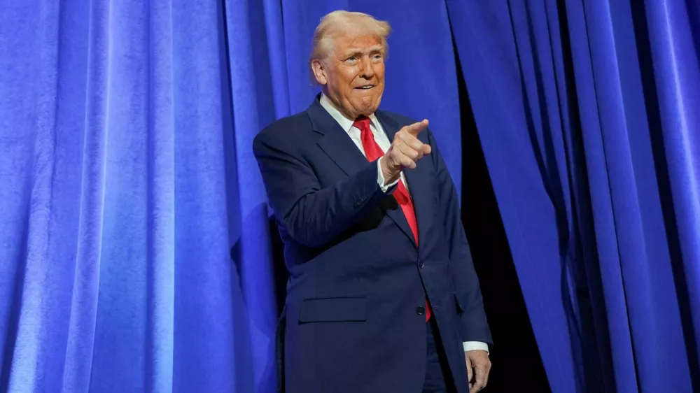 U.S. President Donald Trump gestures during his visit to the Department of Justice to address its workers, in Washington, D.C., U.S., March 14, 2025. REUTERS/Nathan Howard