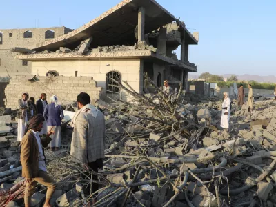 People stand on the rubble of a house hit by a U.S. strike in Saada, Yemen March 16, 2025. REUTERS/Naif Rahma