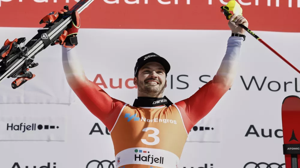 Switzerland's Loic Meillard celebrates on the podium after winning an alpine ski, men's World Cup slalom, in Hafjell, Norway, Sunday, March 16, 2025. (AP Photo/Gabriele Facciotti)