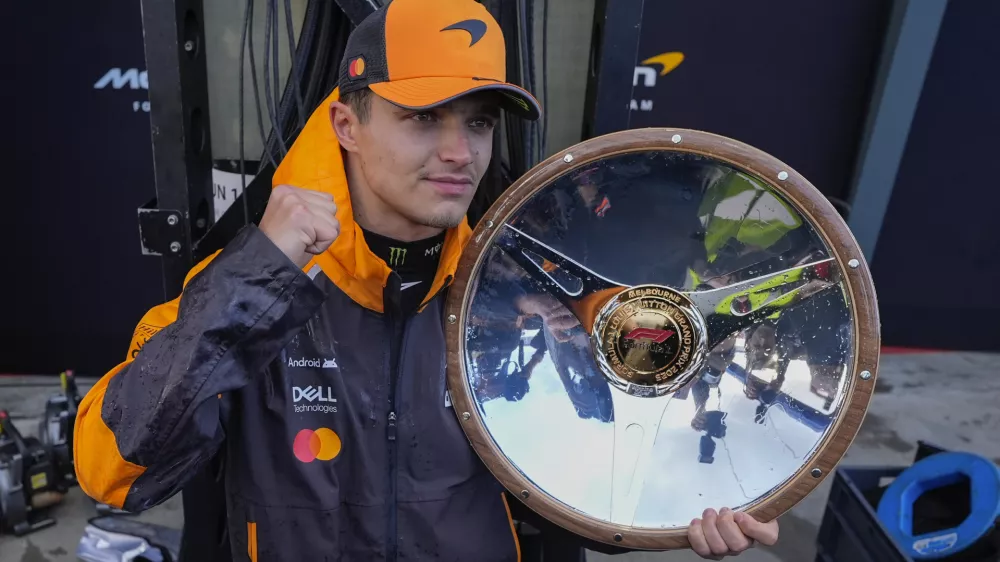 McLaren driver Lando Norris of Britain poses with his trophy after winning the Australian Formula One Grand Prix at Albert Park, in Melbourne, Australia, Sunday, March 16, 2025. (AP Photo/Asanka Brendon Ratnayake)