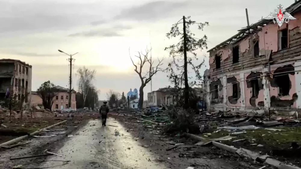 A Russian service member walks past destroyed buildings in the town of Sudzha, which was recently retaken by Russia's armed forces in the course of Russia-Ukraine conflict in the Kursk region, Russia, in this still image from video released March 15, 2025. Russian Defence Ministry/Handout via REUTERS ATTENTION EDITORS - THIS IMAGE HAS BEEN SUPPLIED BY A THIRD PARTY. NO RESALES. NO ARCHIVES. MANDATORY CREDIT.