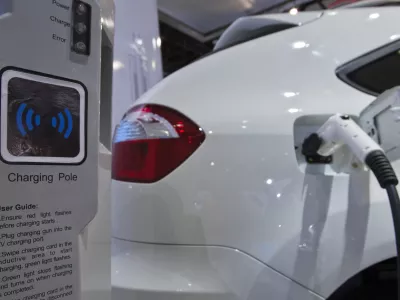 FILE - A display shows how the dual-mode electric S6DM sport utility vehicle from Chinese automaker BYD can be plugged into a charging station to recharge its onboard batteries, at the North American International Auto Show on Monday, Jan. 10, 2011, in Detroit. (AP Photo/Tony Ding, File)