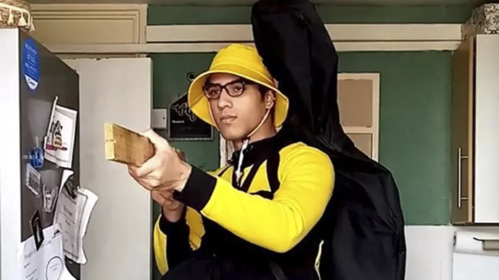 Undated handout screengrab issued by Bedfordshire Police of of teenager Nicholas Prosper holding a plank of wood as a mock gun, pretending to shoot people. (Bedfordshire Police/PA via AP)