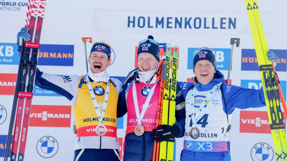 21 March 2025, Norway, Oslo: Oslo 20250321. (L-R) Norway's second placed Sturla Holm Laegreid, winner Johannes Thingnes Boe and third placed Johannes Dale-Skjevdal celebrate on the podium after the men's 10 km in the Biathlon World Cup in Holmenkollen. Photo: Javad Parsa/NTB/dpa
