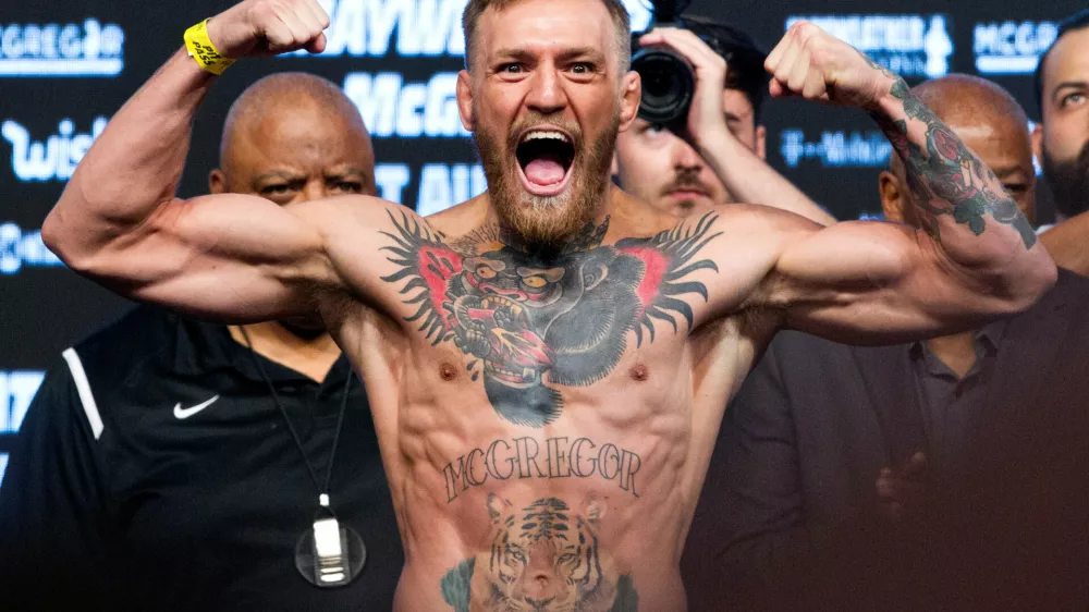 FILE PHOTO: UFC lightweight champion Conor McGregor of Ireland poses on the scale during his official weigh-in at T-Mobile Arena in Las Vegas, Nevada, U.S. on August 25, 2017.  REUTERS/Steve Marcus/File Photo