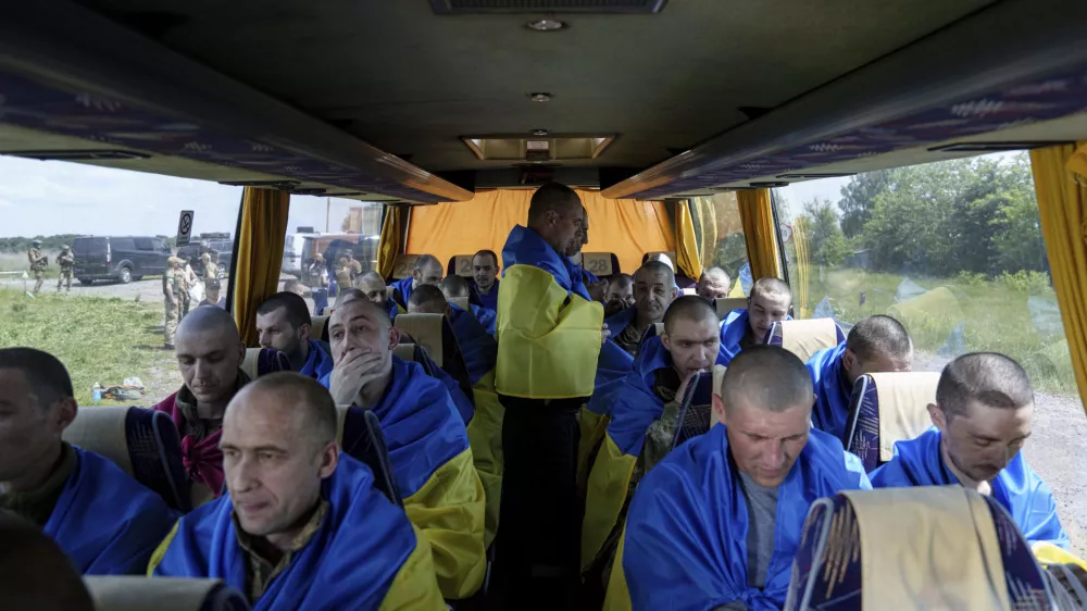 Ukrainian servicemen sit in a bus after returning from captivity during a POWs exchange in Sumy region, Ukraine, Friday, May 31, 2024. Ukraine returned 75 prisoners, including four civilians, in the latest exchange of POWs with Russia. It's the fourth prisoner swap this year, and 52nd since Russia invaded Ukraine. In all, 3 210 Ukrainian servicemen and civilians were returned since the outbreak of the war. (AP Photo/Evgeniy Maloletka)