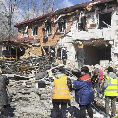 In this photo provided by the Ukrainian Emergency Service, residents clear the rubbles following a Russian drone attack in Kropyvnytskyi, Kirovohrad region, Ukraine, Thursday, March 20, 2025. (Ukrainian Emergency Service via AP)