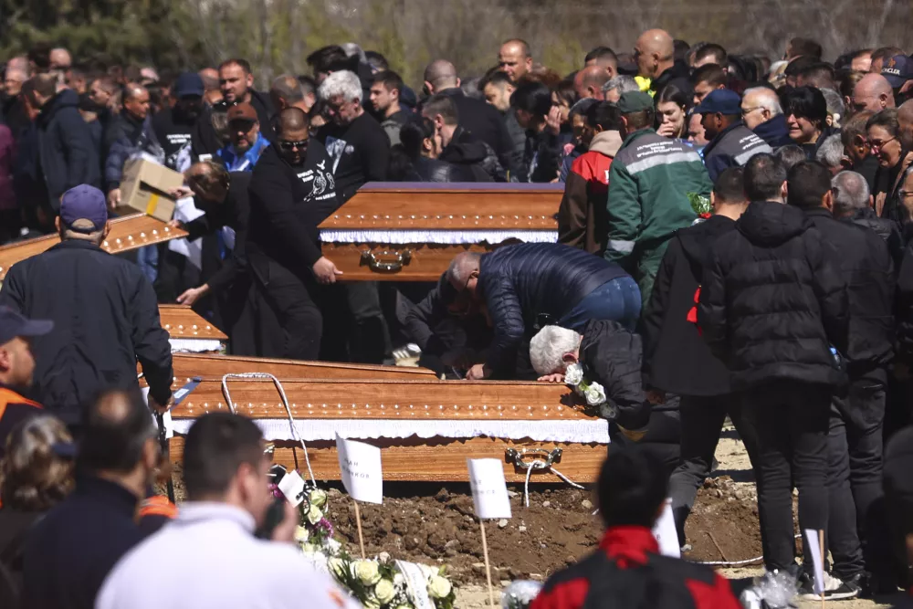 A man cries leaning on a coffin during the funeral ceremony of the victims of a massive nightclub fire in the town of Kocani, North Macedonia, Thursday, March 20, 2025. (AP Photo/Armin Durgut)