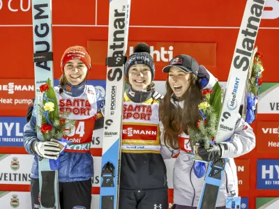 Winner Nika Prevc of Slovenia, centre, second-placed Selina Freitag of Germany, left, and third-placed Alexandria Loutitt of Canada celebrate in the podium of the women's HS130 ski jumping competition at the FIS Nordic World Cup Lahti Ski Games in Lahti, Finland, Thursday March 20, 2025. (Pepe Korteniemi/Lehtikuva via AP)