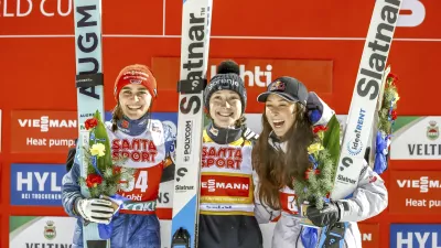 Winner Nika Prevc of Slovenia, centre, second-placed Selina Freitag of Germany, left, and third-placed Alexandria Loutitt of Canada celebrate in the podium of the women's HS130 ski jumping competition at the FIS Nordic World Cup Lahti Ski Games in Lahti, Finland, Thursday March 20, 2025. (Pepe Korteniemi/Lehtikuva via AP)