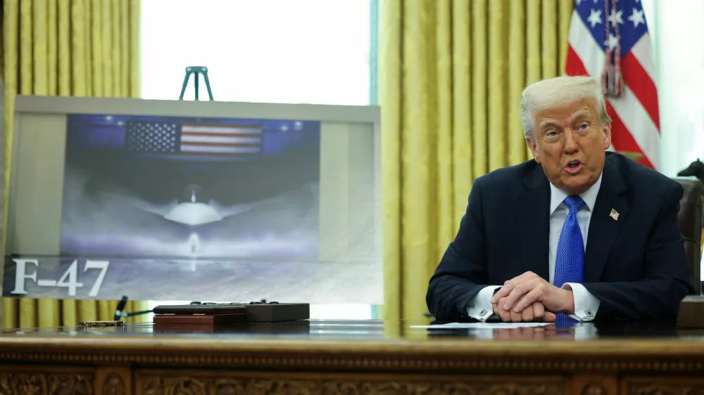 U.S. President Donald Trump delivers remarks, as an image of an F47 is displayed near him, in the Oval Office at the White House, in Washington, D.C., U.S., March 21, 2025. REUTERS/Carlos Barria