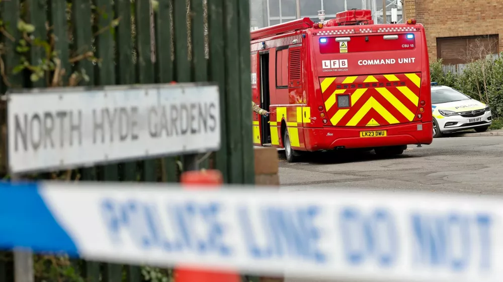 Police officers and firefighters work by the entrance to an electrical substation, a day after it caught fire and wiped out power at Heathrow International Airport, near London, Britain, March 22, 2025. REUTERS/Carlos Jasso