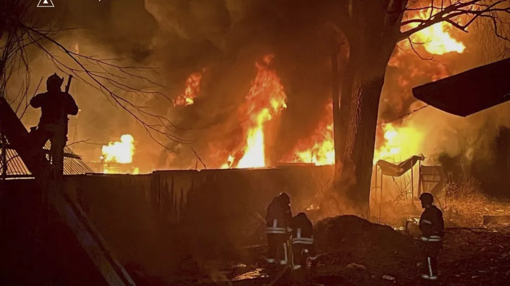 In this photo provided by the Ukrainian Emergency Service, firefighters put out the fire following a Russian attack in near Kyiv, Ukraine, Sunday, March 23, 2025. (Ukrainian Emergency Service via AP)