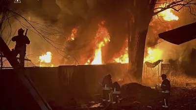In this photo provided by the Ukrainian Emergency Service, firefighters put out the fire following a Russian attack in near Kyiv, Ukraine, Sunday, March 23, 2025. (Ukrainian Emergency Service via AP)