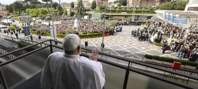 Pope Francis waves as he appears at a window of the Agostino Gemelli Polyclinic in Rome, Sunday, March 23, 2025, where he has been treated for bronchitis and bilateral pneumonia since Feb. 14. (Francesco Sforza/Vatican press office via AP)