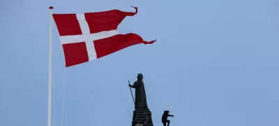 FILE PHOTO: A man walks as Danish flag flutters next to Hans Egede Statue ahead of a March 11 general election in Nuuk, Greenland, March 9, 2025. REUTERS/Marko Djurica/File Photo