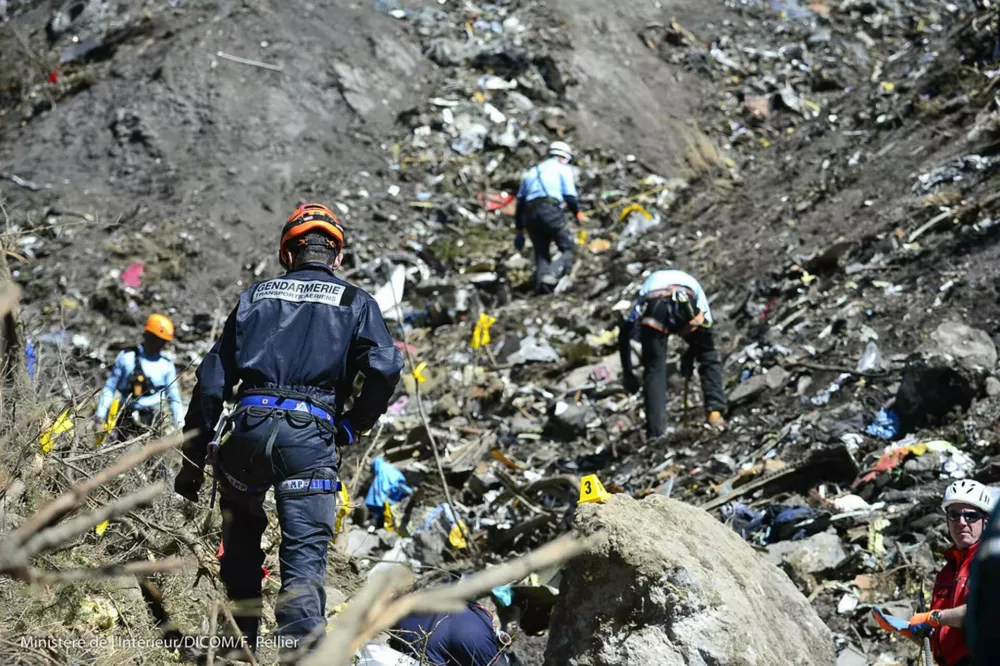 ATTENTION EDITORS - VISUAL COVERAGE OF SCENES OF INJURY OR DEATH French gendarmes and investigators, seen in this picture released by the French Interior Ministry March 26, 2015, make their way through debris from wreckage on the mountainside at the crash site of an Airbus A320, near Seyne-les-Alpes. A young German co-pilot locked himself in the cockpit of Germanwings flight 9525 and flew it into a mountain, killing all 150 people on board including himself, prosecutors said on Thursday. After listening to "black box" voice recordings, French prosecutors left no doubt that they believe 28-year-old Andreas Lubitz was in control of the Airbus A320 and set it on its fatal descent. They offered no explanation for his motive. REUTERS/French Interior Ministry/DICOM/F.Pellier /Handout TPX IMAGES OF THE DAY) FOR EDITORIAL USE ONLY. NOT FOR SALE FOR MARKETING OR ADVERTISING CAMPAIGNS. THIS IMAGE HAS BEEN SUPPLIED BY A THIRD PARTY. IT IS DISTRIBUTED, EXACTLY AS RECEIVED BY REUTERS, AS A SERVICE TO CLIENTS