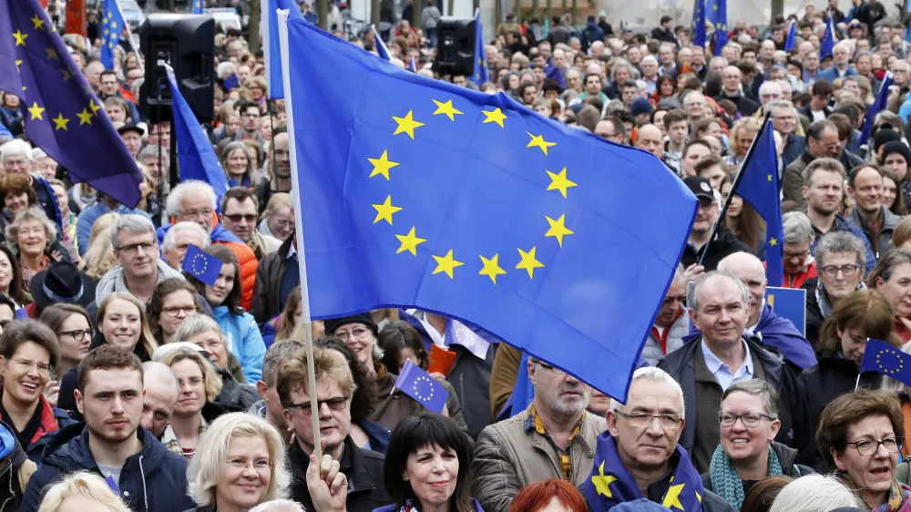 Supporters wave a European flags attending a rally of the Pulse of Europe movement in Frankfurt, Germany, Sunday, March 19, 2017. Pulse of Europe goes to the streets equipped with the symbols of Europe, flags and Ode to Joy. The protesters take a stand for Europe in public for everyone to see. (AP Photo/Michael Probst)