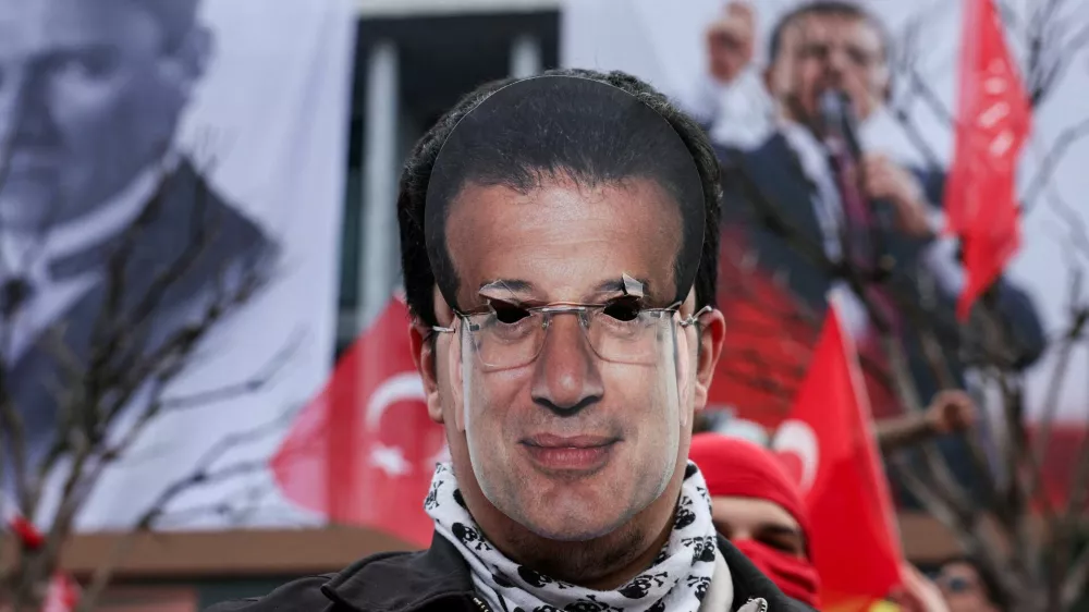 A person wears a cutout mask of Istanbul Mayor Ekrem Imamoglu who was jailed as part of a corruption investigation, during a protest, near Istanbul Metropolitan Municipality building, in Istanbul, Turkey, March 23, 2025. REUTERS/Dilara Senkaya   TPX IMAGES OF THE DAY