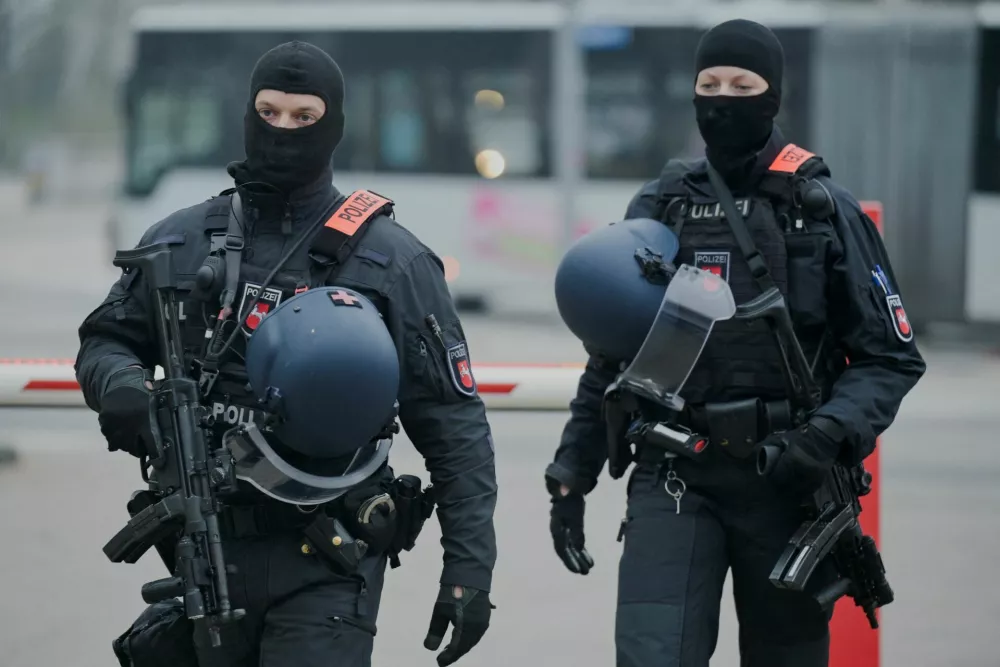 Members of the police patrol near the gate where the convoy of Daniela Klette, accused of being one of the last surviving members of the Red Army Faction group, who was arrested after decades on the run for armed robbery and attempted murder is set to arrive for her trial at a regional court in Celle, Germany March 25, 2025. REUTERS/Fabian Bimmer
