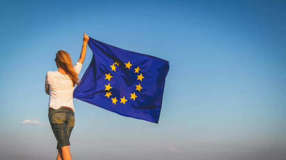 EU flag in female hands.