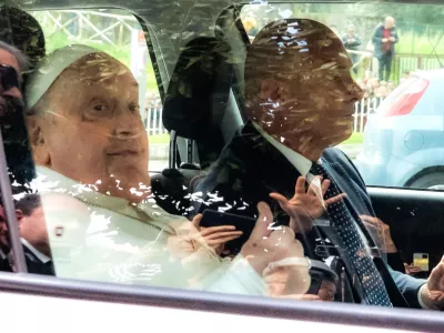 Pope Francis leaves on a car after appearing at a window of the Agostino Gemelli Polyclinic in Rome, Sunday, March 23, 2025, where he has been treated for bronchitis and bilateral pneumonia since Feb. 14. (AP Photo/Stefano Costantino)