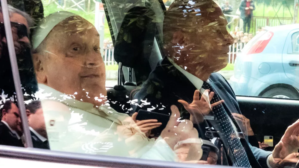 Pope Francis leaves on a car after appearing at a window of the Agostino Gemelli Polyclinic in Rome, Sunday, March 23, 2025, where he has been treated for bronchitis and bilateral pneumonia since Feb. 14. (AP Photo/Stefano Costantino)