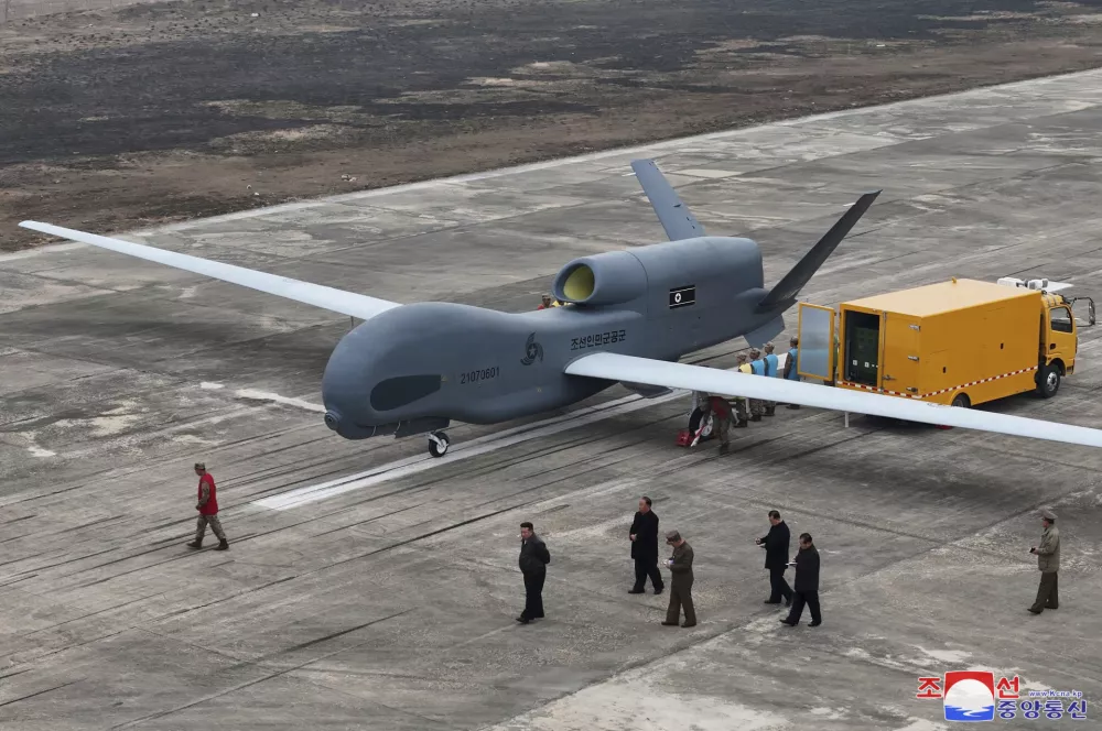 In this photo provided Thursday, March 27, 2025, by the North Korean government, its leader Kim Jong Un, center bottom, walks by what appeared to be a large reconnaissance drone at an undisclosed location in North Korea, earlier this week. Independent journalists were not given access to cover the event depicted in this image distributed by the North Korean government. The content of this image is as provided and cannot be independently verified. Korean language watermark on image as provided by source reads: "KCNA" which is the abbreviation for Korean Central News Agency. (Korean Central News Agency/Korea News Service via AP)