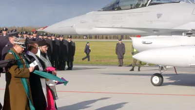 Military chaplains pray in front of one of the first Polish Air Force F-16 fighter jets that arrived at the Krzesiny airport in western Poland, Thursday, Nov. 9, 2006, during the welcoming ceremony. The arrival of the warplanes marks an important step in the transition of Poliand's Soviet equipped army into a modern one, closely integrated with the NATO and the US. (AP Photo/Alik Keplicz)
