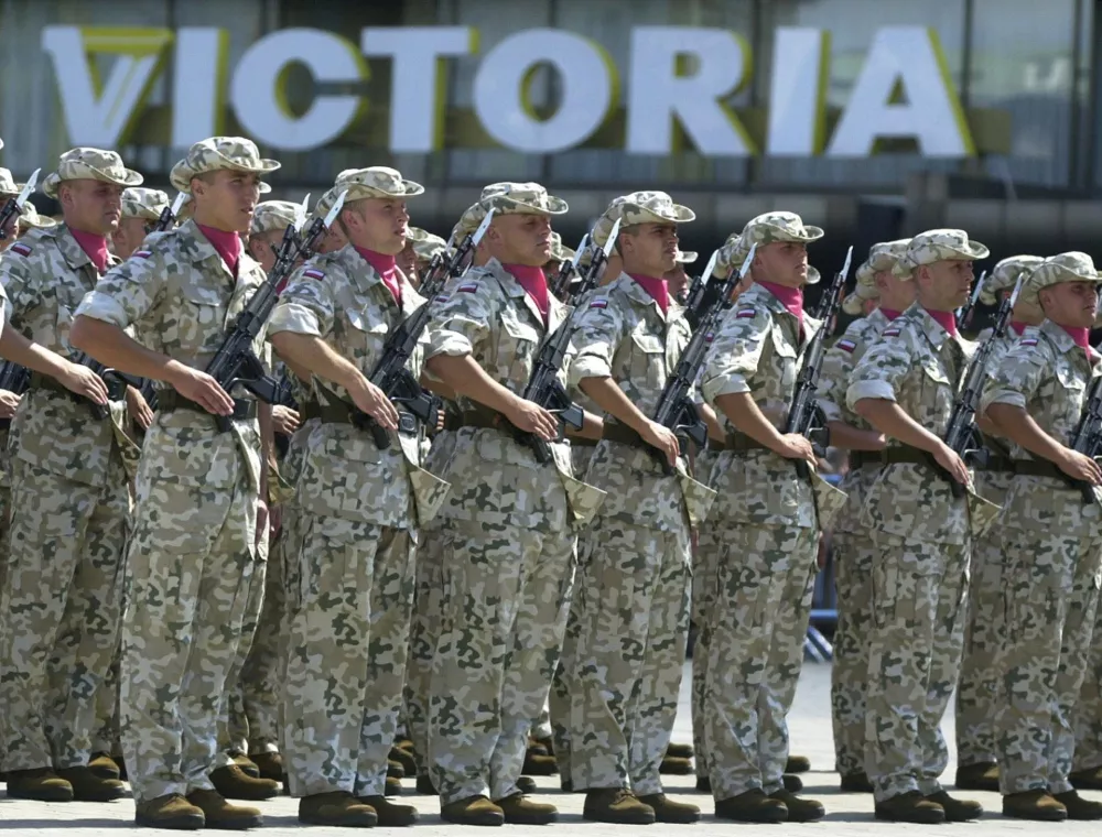 Soldiers representing an air brigade from Tomaszow Mazowiecki, which will take part in the Polish stabilization forces in Iraq, parade during a ceremony to honor the Polish Army Day in Warsaw, Poland, Friday, Aug. 15 2003. (AP Photo/Czarek Sokolowski)