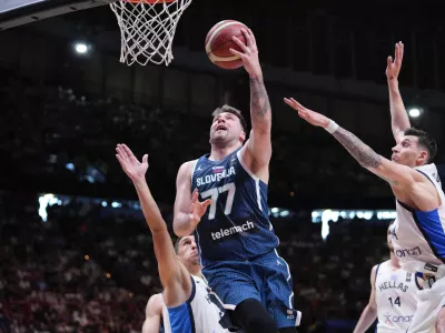 Slovenia's Luka Doncic tries to score against Greece, during an Acropolis tournament basketball match, at the Peace and Friendship indoor stadium at Athens' port city of Piraeus, Saturday, July 6, 2024. (AP Photo/Petros Giannakouris)